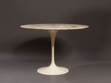 a white table with a marble top on a grey background