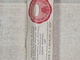 a picture of a piece of wood with a red wax stamp on it