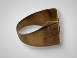 a close up of a gold ring with a cross on it