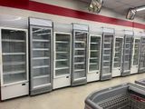 a row of empty refrigerators in a grocery store