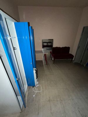 a room with a couch and a refrigerator in it