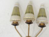 three light wall sconce in the shape of three lamps on a white wall