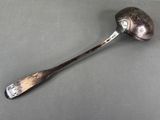 silver spoon with a spoon handle on a gray surface