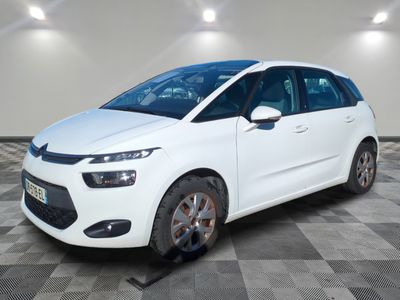 a white citrole is parked in a room with a checkered floor