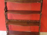 a wooden shelf with three shelves on top of it