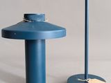 two blue tables that are sitting next to each other