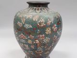 a vase that is sitting on a white surface