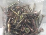 many screws in a bag on a white surface