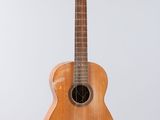 an image of a small wooden guitar hanging from the ceiling