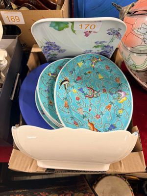 many plates and bowls sitting on a table