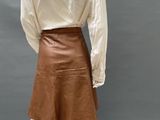 a mannequin mannequin wearing a white shirt and brown skirt