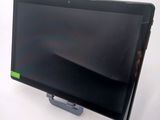 a tablet computer sitting on a stand on a white surface