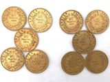 six different types of gold coins on a white surface