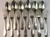a lot of silver spoons and forks on the table