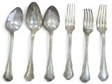 five spoons and a fork on a white surface