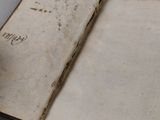 an old book with writing on it sitting on a table