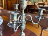 a silver candelab on a wooden table in a living room