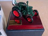 a figurine of a man on a tractor on a table