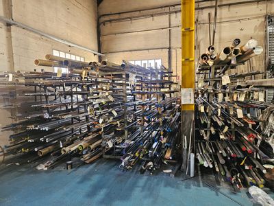 a large pile of pipes and pipes in a warehouse