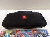 a nintendo wii carrying case and two games on the table