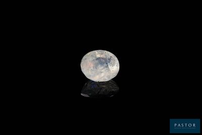 an image of a white moon in the dark sky with a reflection on the ground