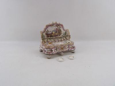 a miniature chair with a mirror on top of it