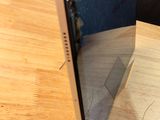 a broken screen sitting on a wooden table