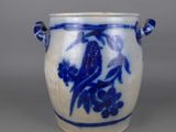 a blue and white vase with a bird on it