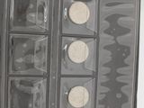 an image of a black and white photo of a box of coins