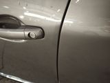 a close up of a car door handle with a sticker on it