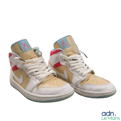 a pair of shoes that are on a white surface