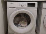 a washer and a dryer in a small room