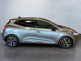 a silver car is parked in a room with a white wall