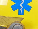 a yellow fire hydrant with a blue star of life sticker on it