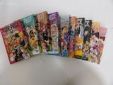 five books of one piece comics sitting on top of a white table