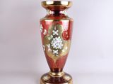 a red vase with a gold base on a white background