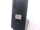 the back of a black samsung phone with a barcode on it