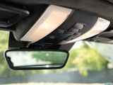 the rear view mirror of a car with a speaker in the rear view mirror