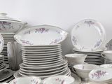 a lot of plates and bowls on the table