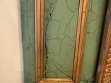 peeling paint on the wall of a bathroom with a toilet in the corner