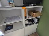 a tv on a shelf in the corner of a room