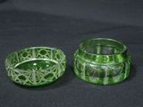 pair of green glass votives on a black cloth