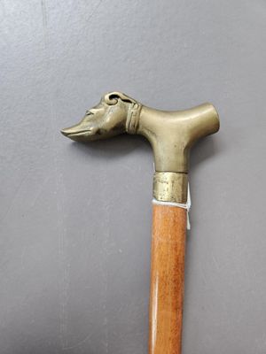 a cane with a dog head on it on a table