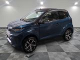 la voiture bleue est garée sur le sol en damier d'un garage