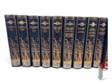 six books in a row on a white background with a red ribbon