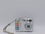 a silver camera sitting on a white surface