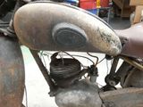an old motorcycle that is sitting in the garage