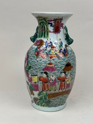 un vase avec un tableau posé sur une table