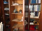 a tall wooden bookcase with many books in it