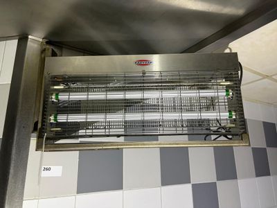 a large metal heater hanging from the ceiling in a kitchen